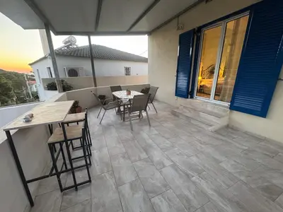 a patio with a table and chairs on a house at Detached House KATAFIGI in Palaiá Fókaia