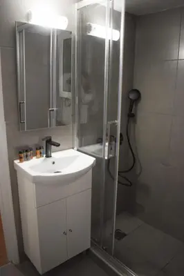 a bathroom with a shower with a sink and a shower at Location...Acropolis! in Athens