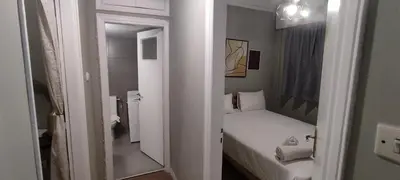 a small room with a bed and a mirror at Location...Acropolis! in Athens