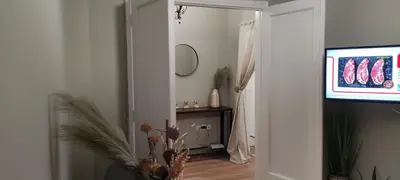 a living room with a television and a hallway at Location...Acropolis! in Athens