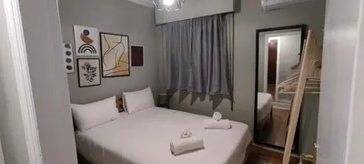a small bedroom with a bed with two towels on it at Location...Acropolis! in Athens