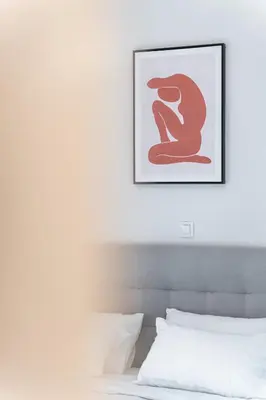 a bedroom with a bed with a picture on the wall at Spacious 2BD apt next to metro in Athens