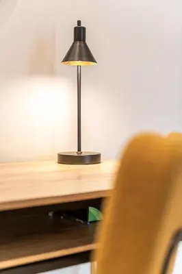 a black lamp sitting on top of a wooden desk at Spacious 2BD apt next to metro in Athens