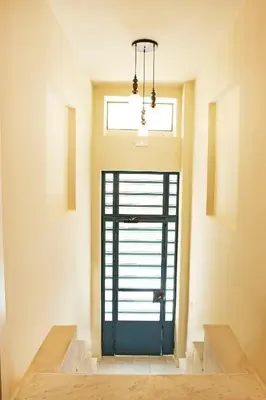 a blue door in a room with a window at Lovely 1st Fl. Apt, with Balcony in Pagrati in Athens