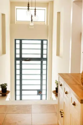 a kitchen with a large window and a large door at Lovely 1st Fl. Apt, with Balcony in Pagrati in Athens