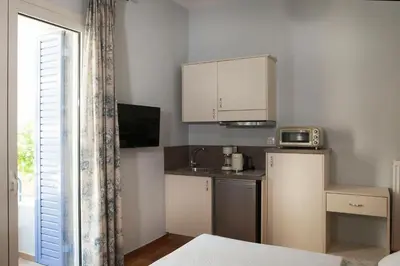a small kitchen with a sink and a refrigerator at Lovely 1st Fl. Apt, with Balcony in Pagrati in Athens