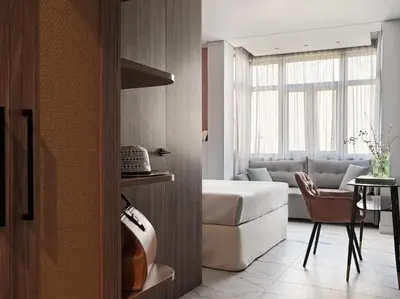 a bedroom with a bed and a living room at Athens City View Urban Suites in Athens