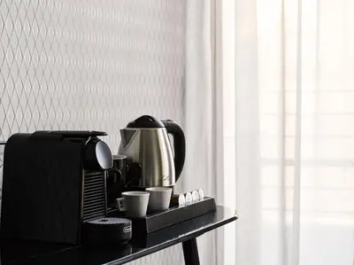 a table with a coffee maker and cups on it at Athens City View Urban Suites in Athens