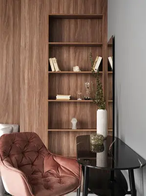 a room with a chair and a table and a book shelf at Athens City View Urban Suites in Athens
