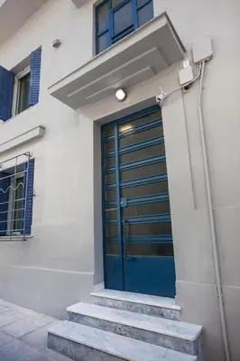 a blue door on the side of a building at Pagrati/Hilton area, Bentzi (3) Boutique Apt. for 4 in Athens