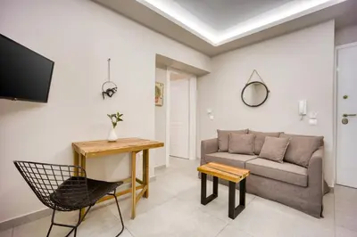 a living room with a couch and a table at Pagrati/Hilton area, Bentzi (3) Boutique Apt. for 4 in Athens