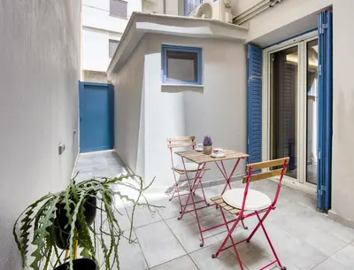 a small patio with a table and chairs on a balcony at Pagrati/Hilton area, Bentzi (3) Boutique Apt. for 4 in Athens