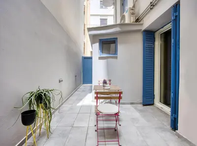 a small balcony with a table and chairs in a building at Pagrati/Hilton area, Bentzi (3) Boutique Apt. for 4 in Athens