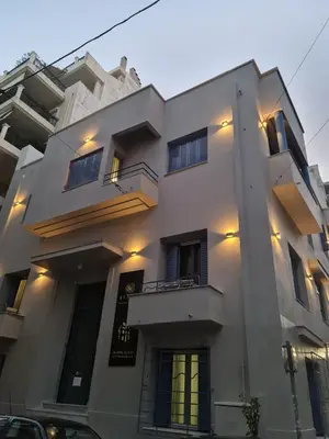 a large white building with a lot of windows at Pagrati/Hilton area, Bentzi (3) Boutique Apt. for 4 in Athens