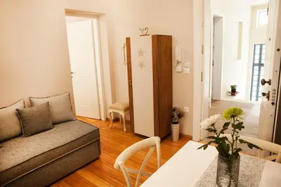 a living room with a couch and a table at 2-spaces comfy Bentzi apartment 7 with balcony in Pagrati in Athens