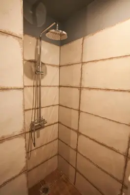 a shower with a shower head in a bathroom at 2-spaces comfy Bentzi apartment 7 with balcony in Pagrati in Athens