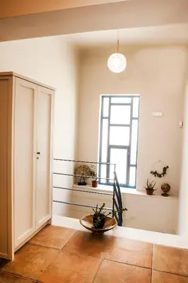 a living room with a table and a window at 2-spaces comfy Bentzi apartment 7 with balcony in Pagrati in Athens