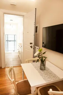 a living room with a white table with a plant on it at 2-spaces comfy Bentzi apartment 7 with balcony in Pagrati in Athens
