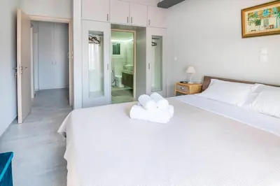 a bedroom with a white bed with two towels on it at The 