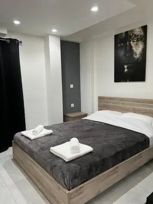 a bedroom with a large bed with two towels on it at Thiseio Residence- Studio 55 in Athens