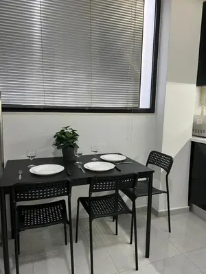 a black table and chairs with a plant on it at Thiseio Residence- Studio 55 in Athens
