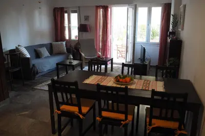 a living room with a table and chairs and a couch at Cicada 's Song in Athens