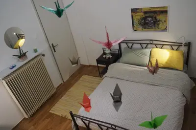 a bedroom with a bed with birds on it at Cicada 's Song in Athens