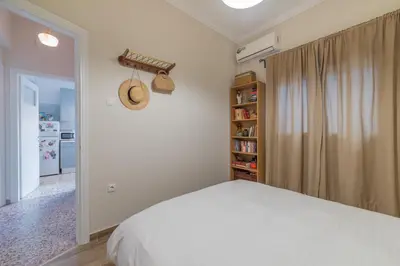 a bedroom with a bed and a book shelf at Vintage-style Garden Apartment in Athens