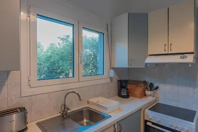a kitchen with a sink and a window at Vintage-style Garden Apartment in Athens