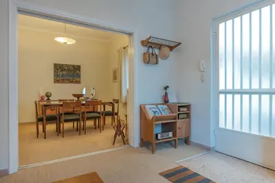 a dining room with a table and a dining roomiasm at Vintage-style Garden Apartment in Athens