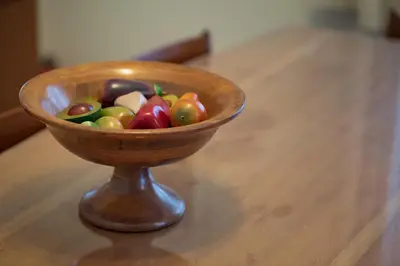 a wooden bowl of vegetables sitting on a table at Vintage-style Garden Apartment in Athens