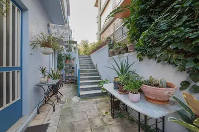 an alley with potted plants and stairs in a building at Vintage-style Garden Apartment in Athens