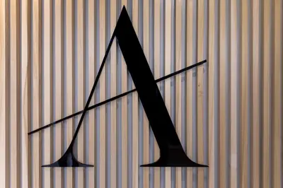 a large black arrow on a striped wall at Arcade Hotel Athens in Athens