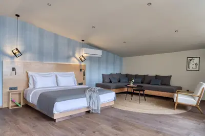 a hotel room with a bed and a couch at Arcade Hotel Athens in Athens