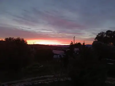 a sunset over a field with the sun setting at ΟΔΥΣΣΕΙΑ, κοντά σε αεροδρόμιο, λιμάνια και θάλασσες in Keratea