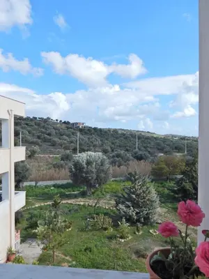 a view from the balcony of a building with flowers at ΟΔΥΣΣΕΙΑ, κοντά σε αεροδρόμιο, λιμάνια και θάλασσες in Keratea