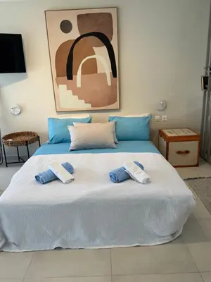 a bedroom with a bed with two towels on it at Sophia's apartment in Saronida