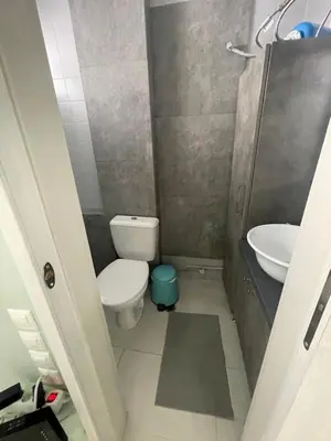 a small bathroom with a toilet and a sink at Sophia's apartment in Saronida
