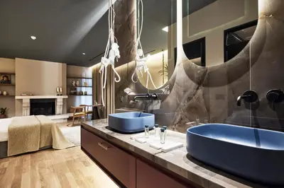 a bathroom with two blue sinks on a counter at Cama Luxury Suites Glyfada in Athens
