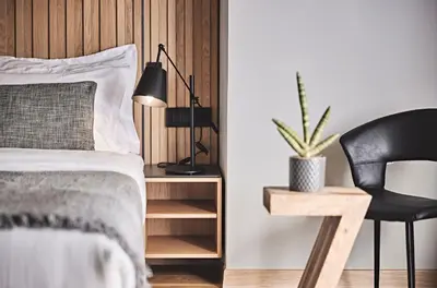 a bedroom with a bed and a chair and a desk at Cama Luxury Suites Glyfada in Athens