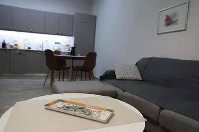 a living room with a couch and a table at Όμορφο διαμέρισμα σε διατηρητέο κτίσμα στην Αθήνα in Athens