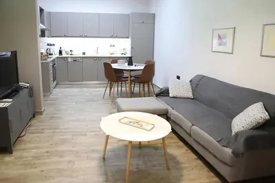 a living room with a couch and a table at Όμορφο διαμέρισμα σε διατηρητέο κτίσμα στην Αθήνα in Athens