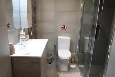 a bathroom with a shower and a toilet and a sink at Όμορφο διαμέρισμα σε διατηρητέο κτίσμα στην Αθήνα in Athens