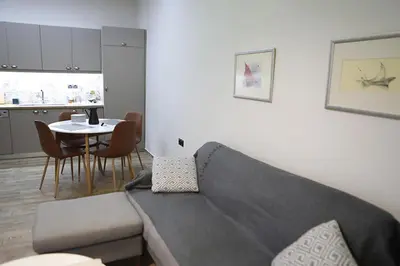a living room with a couch and a table at Όμορφο διαμέρισμα σε διατηρητέο κτίσμα στην Αθήνα in Athens
