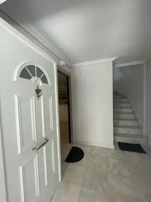 a white door in a hallway with a staircase at Kalimera Alimos Apartment in Athens