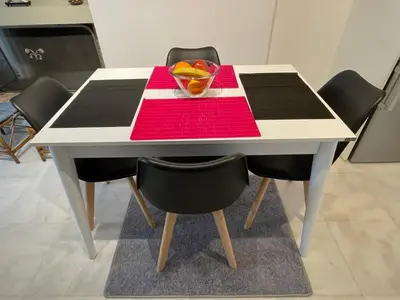 a table with a bowl of fruit on top of it at Kalimera Alimos Apartment in Athens