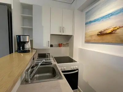 a kitchen with a sink and a counter top at Kalimera Alimos Apartment in Athens