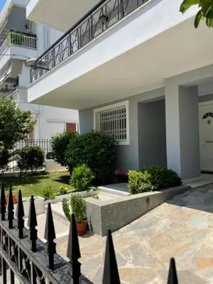 a fence in front of a house with a staircase at Kalimera Alimos Apartment in Athens