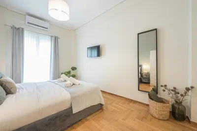 a bedroom with a large bed and a mirror at The 