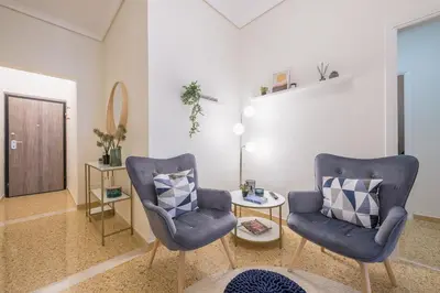 a living room with two chairs and a table at The 